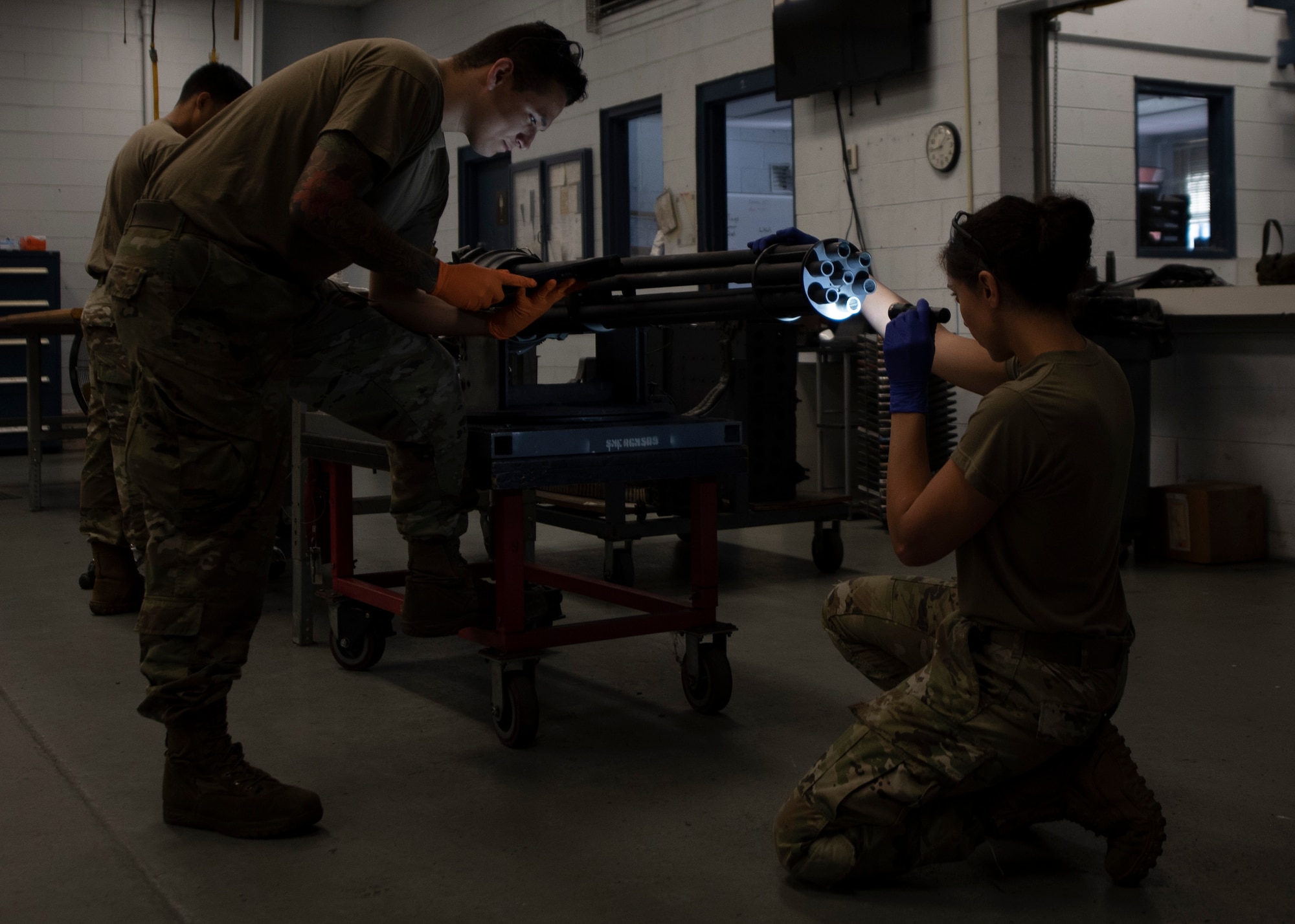 Tech. Sgt. Katrina Rubisch, 4th Equipment Maintenance Squadron armament maintenance supervisor (right) and Senior Airman Geoffrey Negrete, 4 EMS armament systems technician (left), inspect the barrels of an F-15E Strike Eagle 22mm gun for corrosion at Seymour Johnson Air Force Base, North Carolina, Oct. 1, 2020.