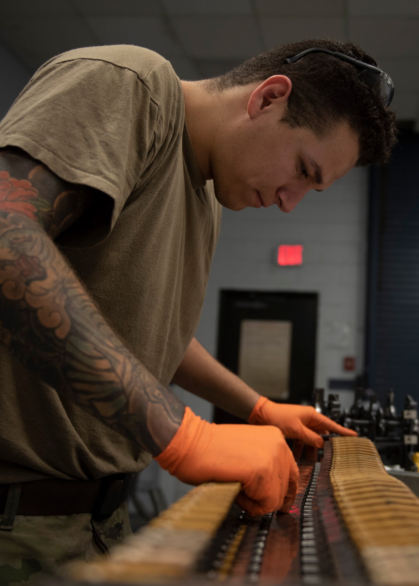 Senior Airman Geoffrey Negrete, 4 EMS armament systems technician, inspects a component of the F-15E Strike Eagle 22mm gun at Seymour Johnson Air Force Base, North Carolina, Oct. 1, 2020.