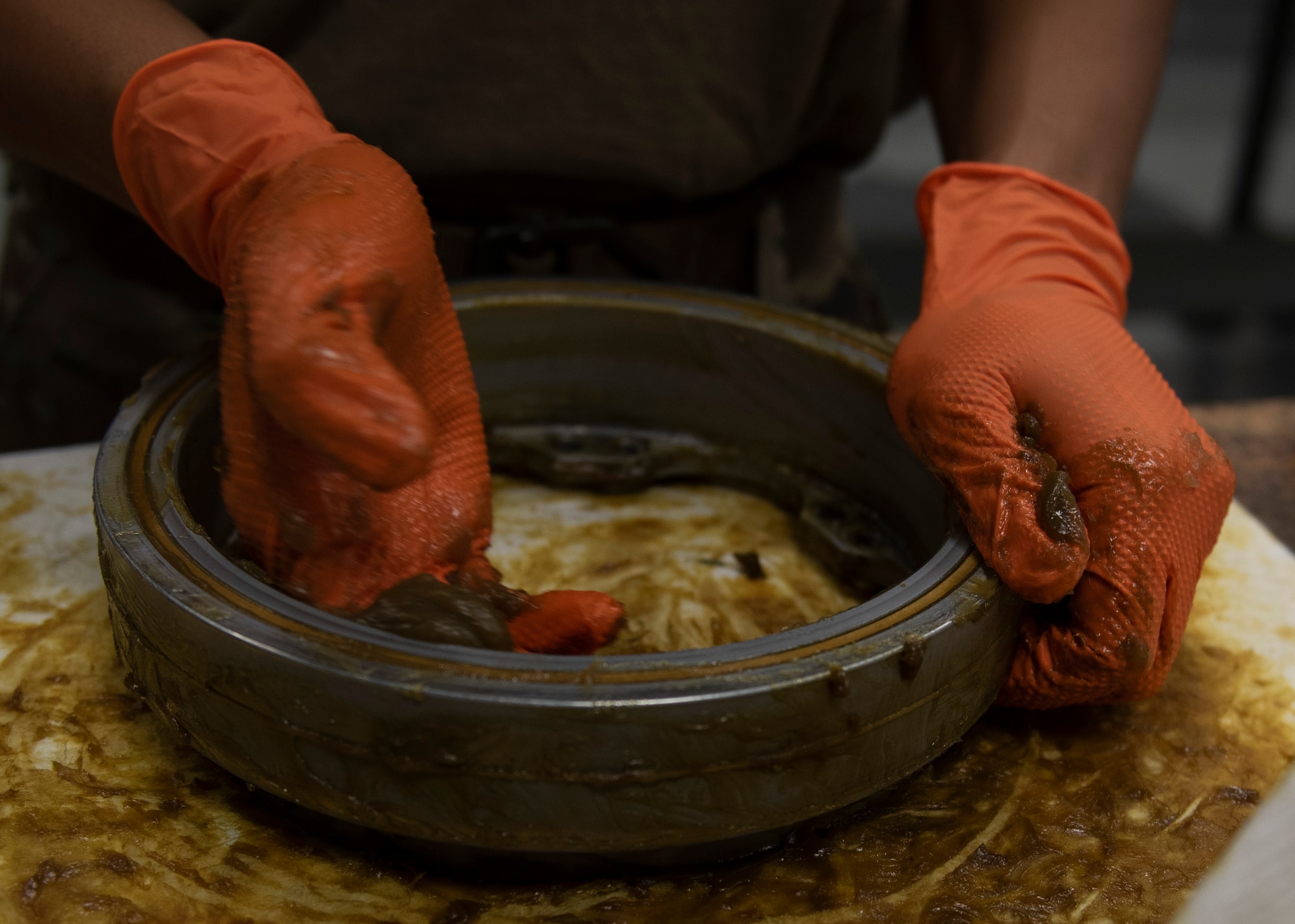 Senior Airman William Vongkhamchanh, 4th Equipment Maintenance Squadron armament maintenance technician, packs a 22mm gun bearing during an 18-month gun inspection at Seymour Johnson Air Force Base, North Carolina, Oct. 1, 2020.