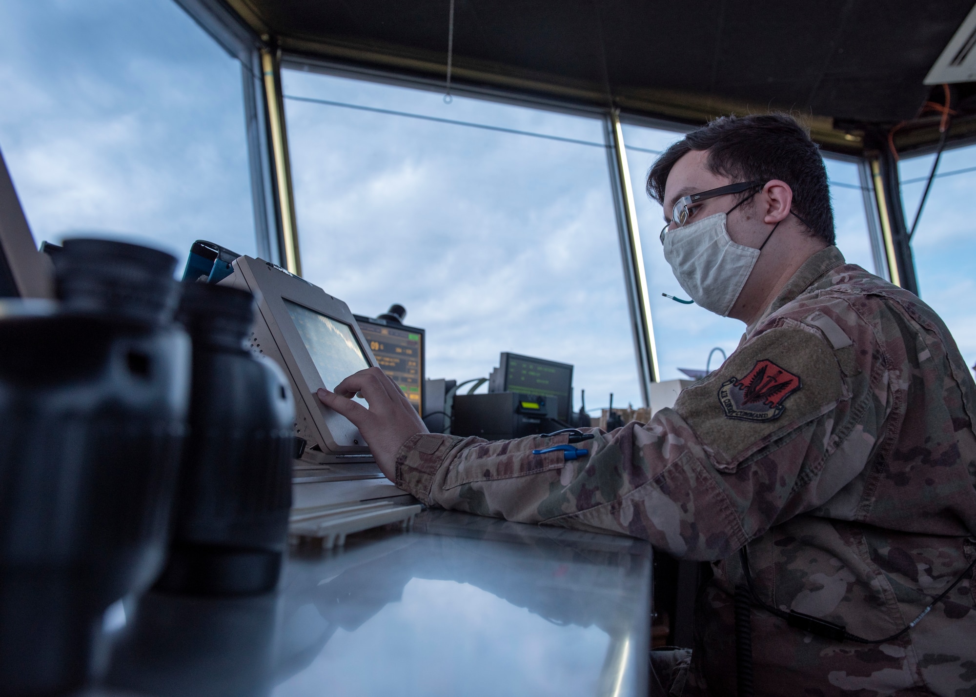 Senior Airman Elias De La Torre, 4th Operations Support Squadron air traffic control journeyman, uses an enhance terminal voice switch (ETVS) to communicate with base facilities, aircraft and flightline vehicles at Seymour Johnson Air Force Base, North Carolina, Oct. 2, 2020.