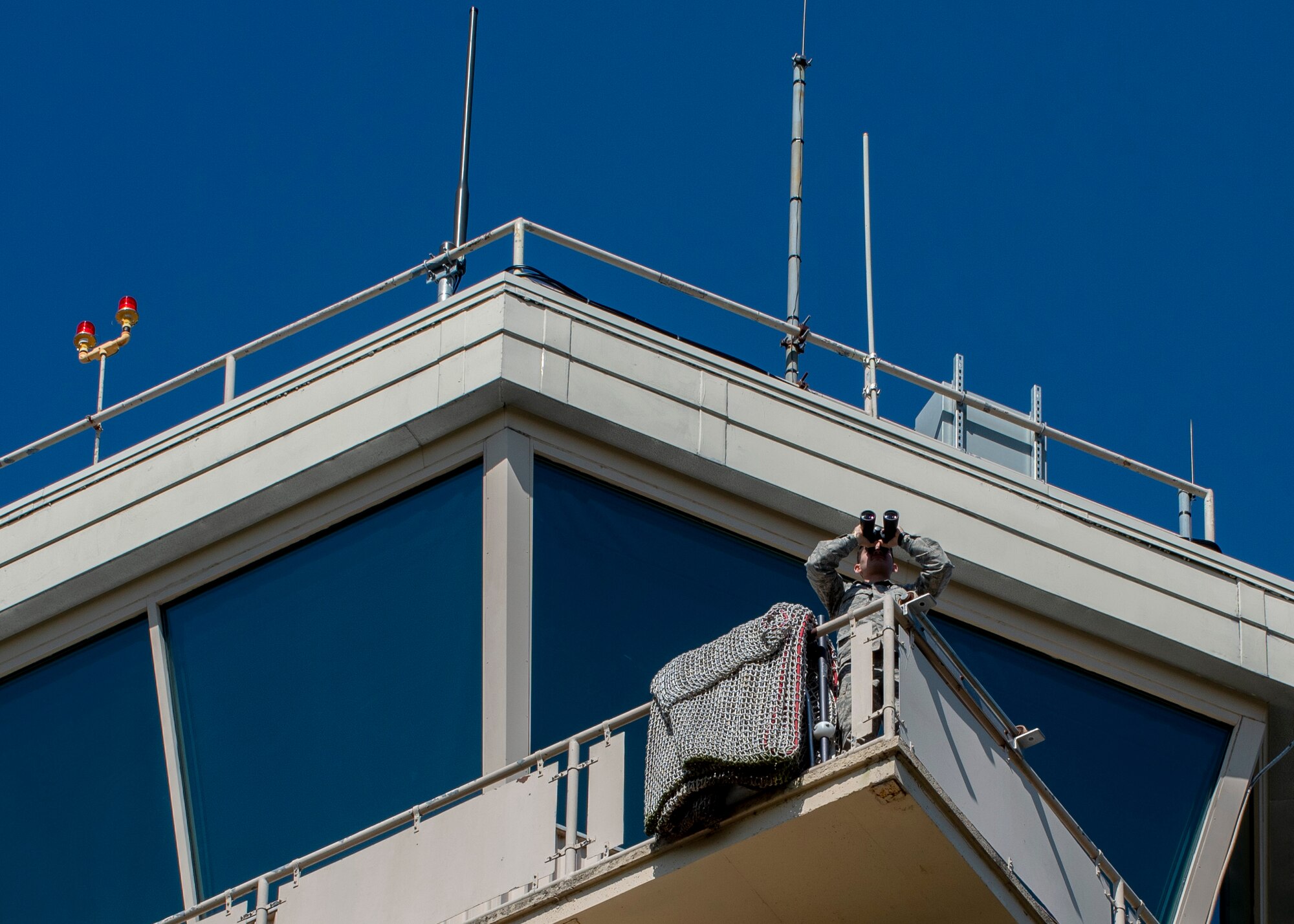Airman 1st Class Noah Romero, 4th Operations Support Squadron air traffic controller apprentice, uses binoculars to locate distant aircraft, check on landing gear, and look for birds at Seymour Johnson Air Force Base, North Carolina, Oct. 2, 2020.