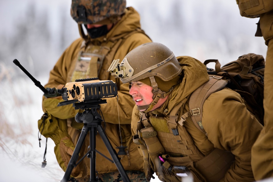 U.S. Marine Corps Lance Cpl. Jarrett Dittenber, a 1st Air Naval Gunfire Liaison Company forward observer, uses binoculars during RED FLAG-Alaska 21-1 in the Joint Pacific Alaska Range Complex, Oct. 15, 2020.
