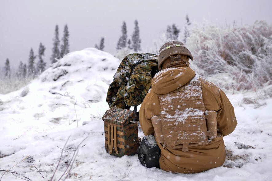 U.S. Marine Corps Lance Cpl. Jarrett Dittenber, a 1st Air Naval Gunfire Liaison Company (ANGLICO) forward observer, sits by his gear during RED FLAG-Alaska 21-1 in the Joint Pacific Alaska Range Complex, Oct. 15, 2020.