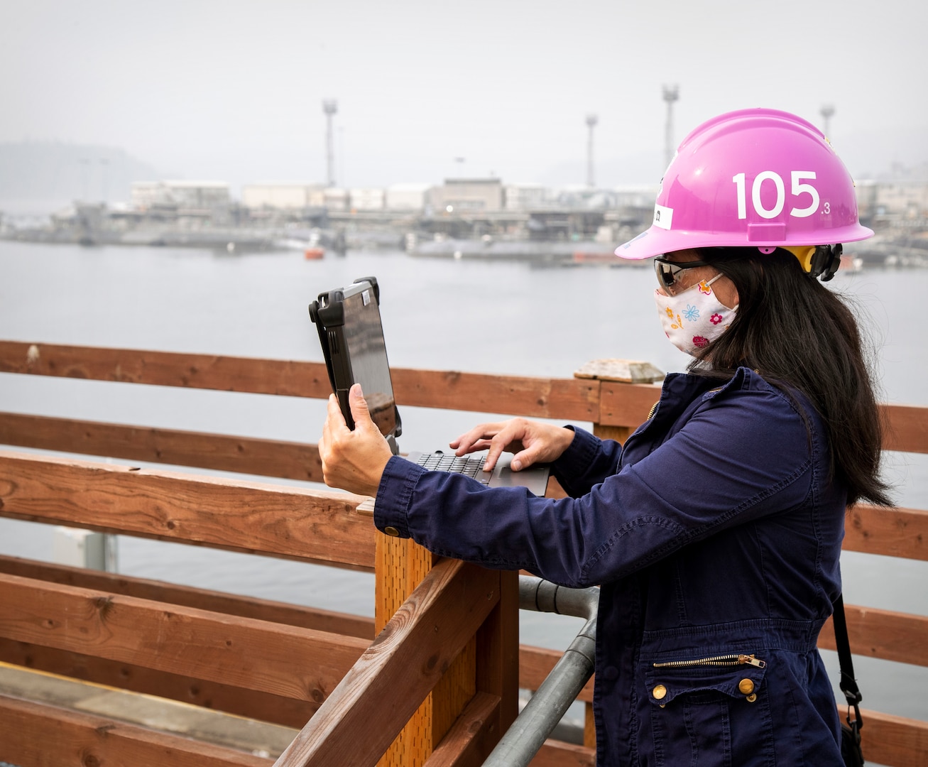 Anh Tran with Code 105, Radiological Controls, uses a tablet while conducting work on the Puget Sound Naval Shipyard & Intermediate Maintenance Facility waterfront as part of the command’s Mobile Workforce Enablement initiative, which increases efficiency, reduces delays and puts valuable information within reach of employees, wherever they are working. (PSNS & IMF photo by Wendy Hallmark)