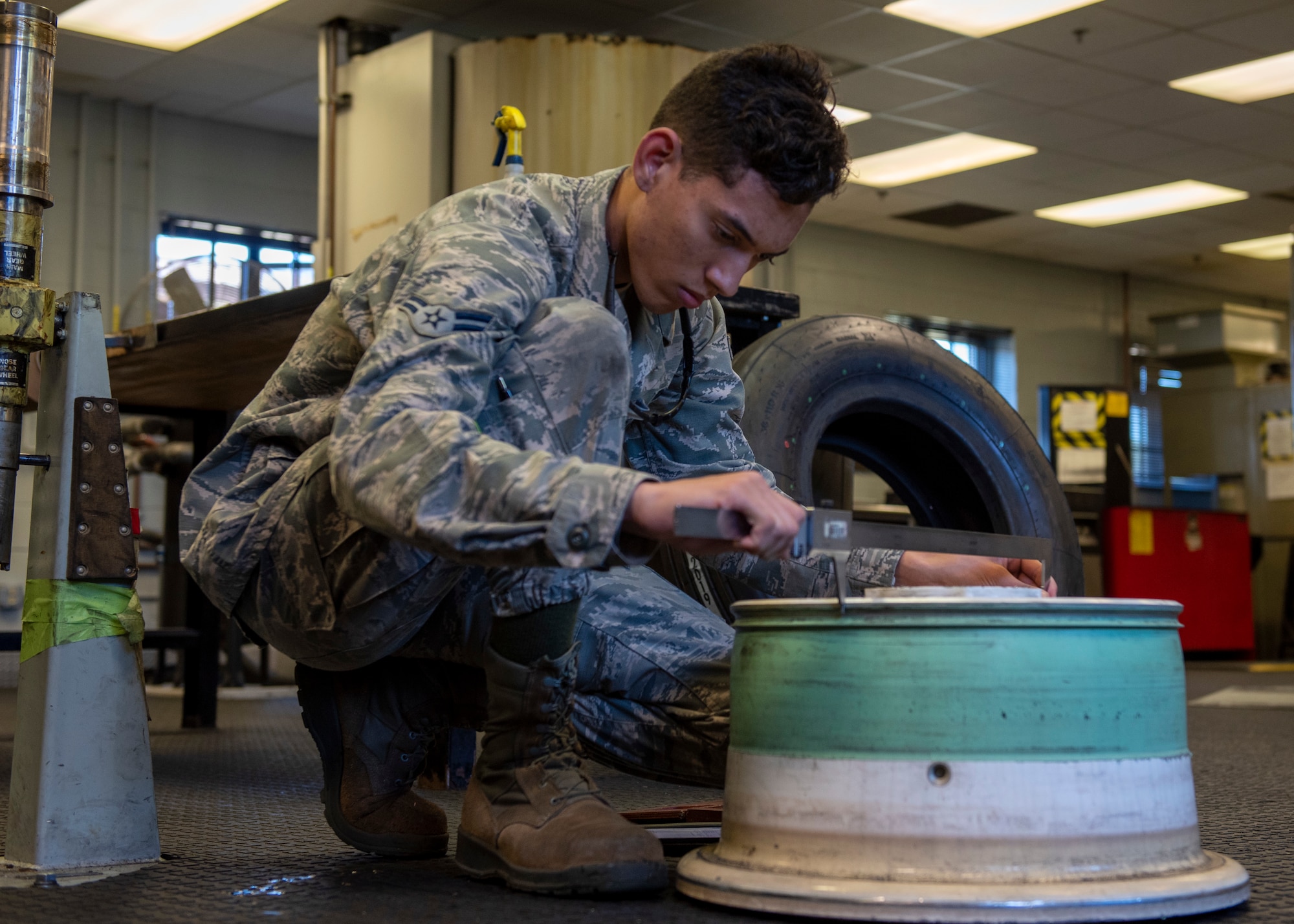 Airman 1st Class Dominic Kirkner, 4th Equipment Maintenance Squadron aircraft metals technologies, uses a large dial caliper to check the dimensions of an F-15E Strike Eagle wheel at Seymour Johnson Air Force Base, North Carolina, Oct. 14, 2020.