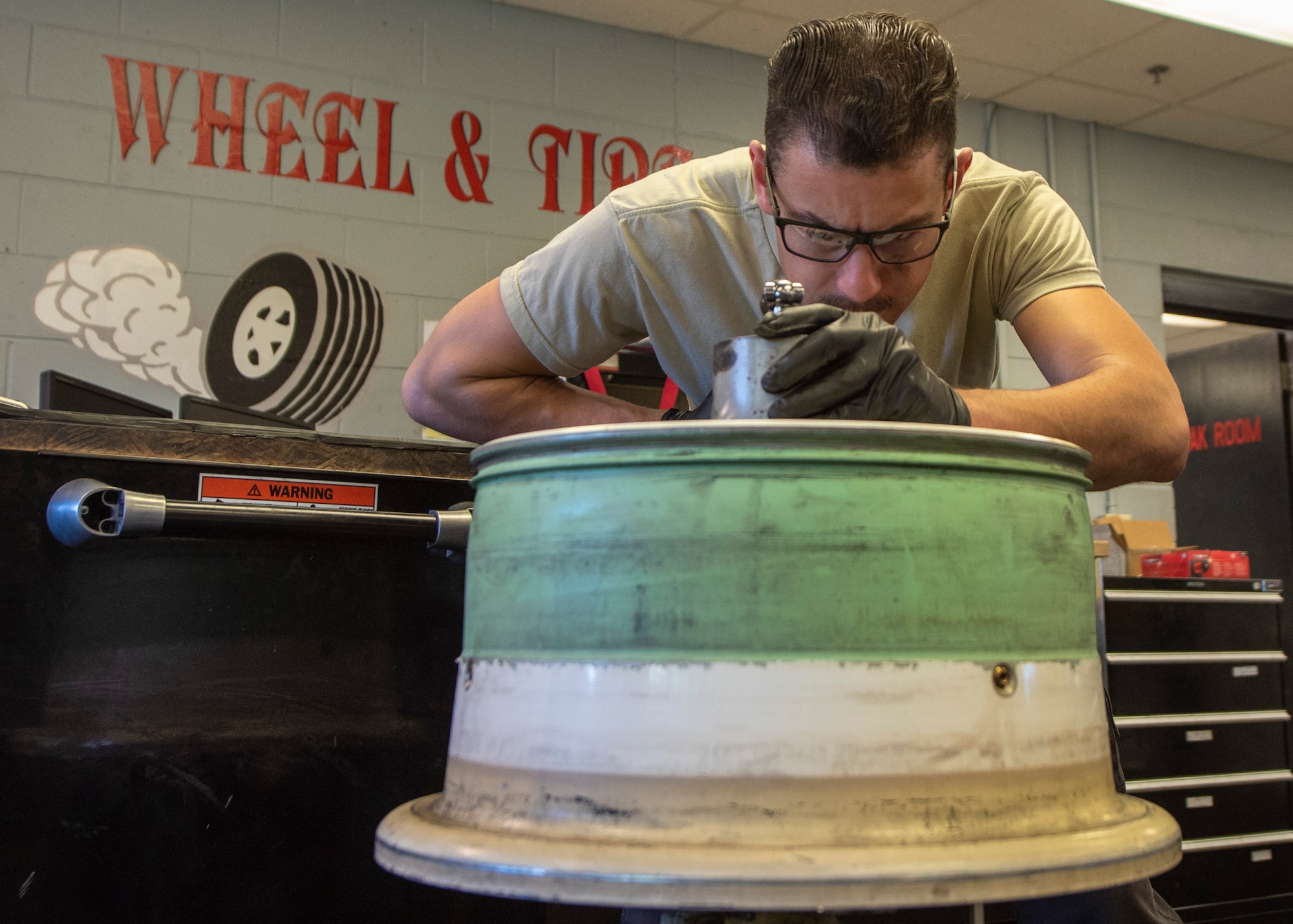 Senior Airman Lyman Patee, 4th Equipment Maintenance Squadron crash recovery wheel and tire craftsman, performs a main landing gear wheel and tire assembly rebuild on the back wheel of an F-15E Strike Eagle at Seymour Johnson Air Force Base, North Carolina, Oct. 14, 2020.