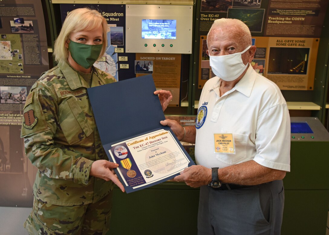 U.S. Air Force Chief Master Sgt. Casy Boomershine, 17th Training Wing command chief, presents  Ret. Col. Jack Mecham, former SR-71 pilot with a certificate of appreciation at Norma Brown on Goodfellow Air Force Base, Texas, Oct. 13, 2020. Mecham flew 23 different kinds of aircraft during his time in the Air Force. (U.S. Air Force photo by Airman 1st Class Ethan Sherwood)