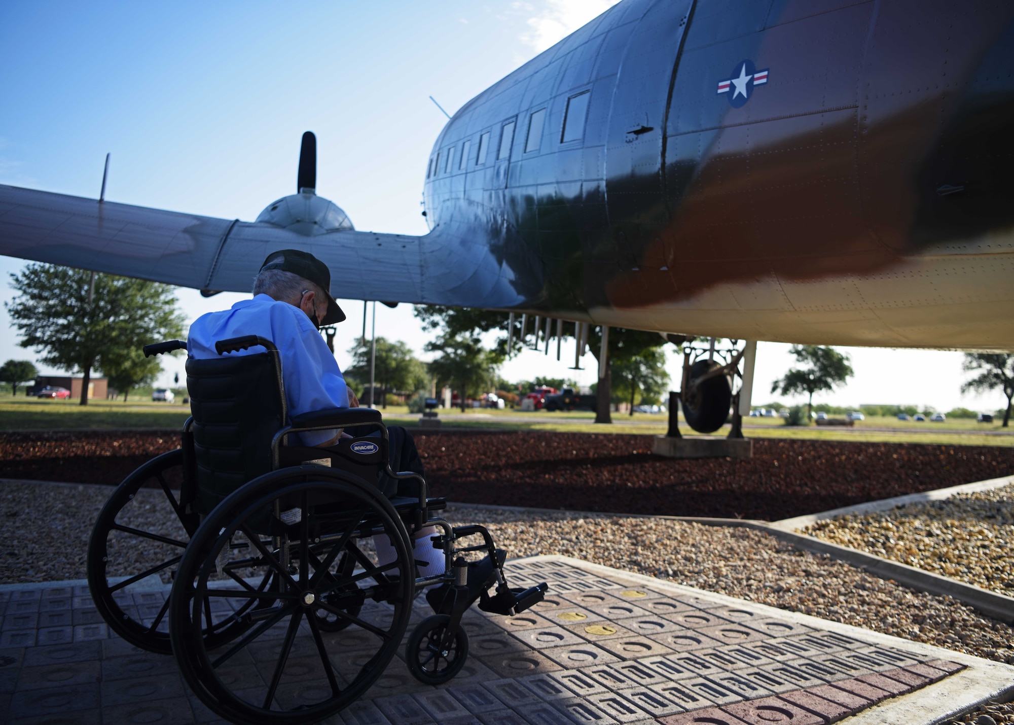 Ret. Master Sgt. Jim Coffman, former EC-47 flight engineer sits in front of the EC-47 Memorial reflecting on his time in the service at the EC-47 Memorial on Goodfellow Air Force Base, Texas, Oct. 13, 2020. Coffman served all around the globe during his time in the Air Force and even flew with Buzz Aldrin. (U.S. Air Force photo by Airman 1st Class Ethan Sherwood)
