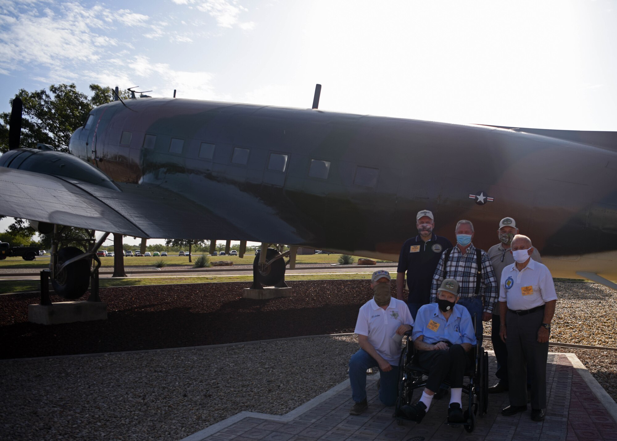 Vietnam Veterans and members of Goodfellow pose in front of the EC-47 Memorial on Goodfellow Air Force Base, Texas, Oct. 13, 2020. The ceremony was rescheduled to 2021, but the veterans came out early to see the pavers in advance. (U.S. Air Force photo by Airman 1st Class Ethan Sherwood)