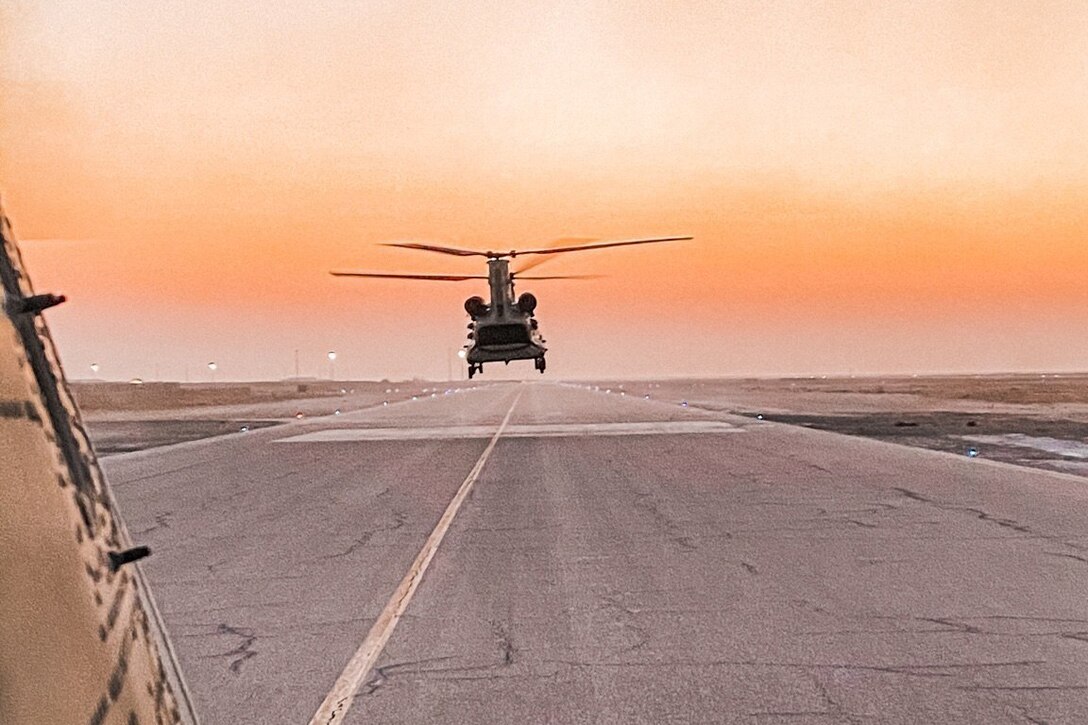 A helicopter takes off from an airfield.