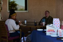 A photo of a military spouse talking to a cop
