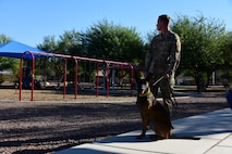 A photo of a dog handler and his dog