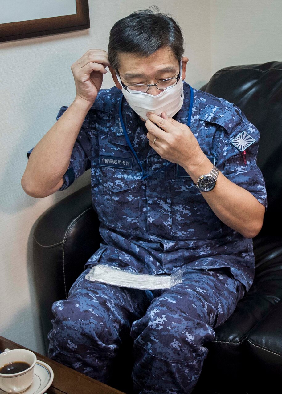 Vice Adm. Hideki Yuasa, commander in chief, Self Defense Fleet, Japan Maritime Self Defense Force, dons a mask handmade by U.S. 7th Fleet ECC Director, Capt. James J. Mehail’s wife, Despina, during a visit to the 7th Fleet command ship USS Blue Ridge (LCC 19). As the U.S. Navy’s largest forward-deployed fleet, there are roughly 50-70 ships and submarines, 150 aircraft, and approximately 20,000 Sailors operating in the 7th Fleet area of operations.