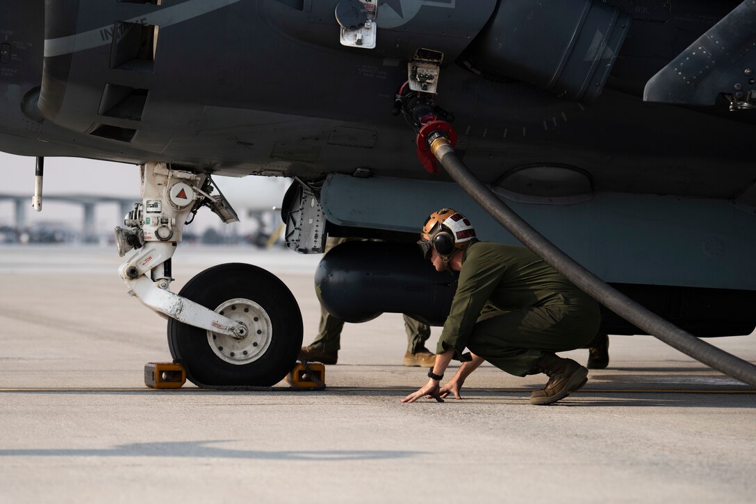 A U.S. Marine with Marine Attack Squadron 542, inspects a chock on an AV-8B II Harrier, at Mountain Home Air Force Base, Idaho, Oct. 8, 2020. VMA 542 and Marine Wing Support Squadron 271 worked closely with 366th Logistics Readiness Squadron fuels flight and provided aviation fuel, heavy equipment and utilities support for exercise Mountain Tiger. (U.S Air Force photo by Airman 1st Class Natalie Rubenak)