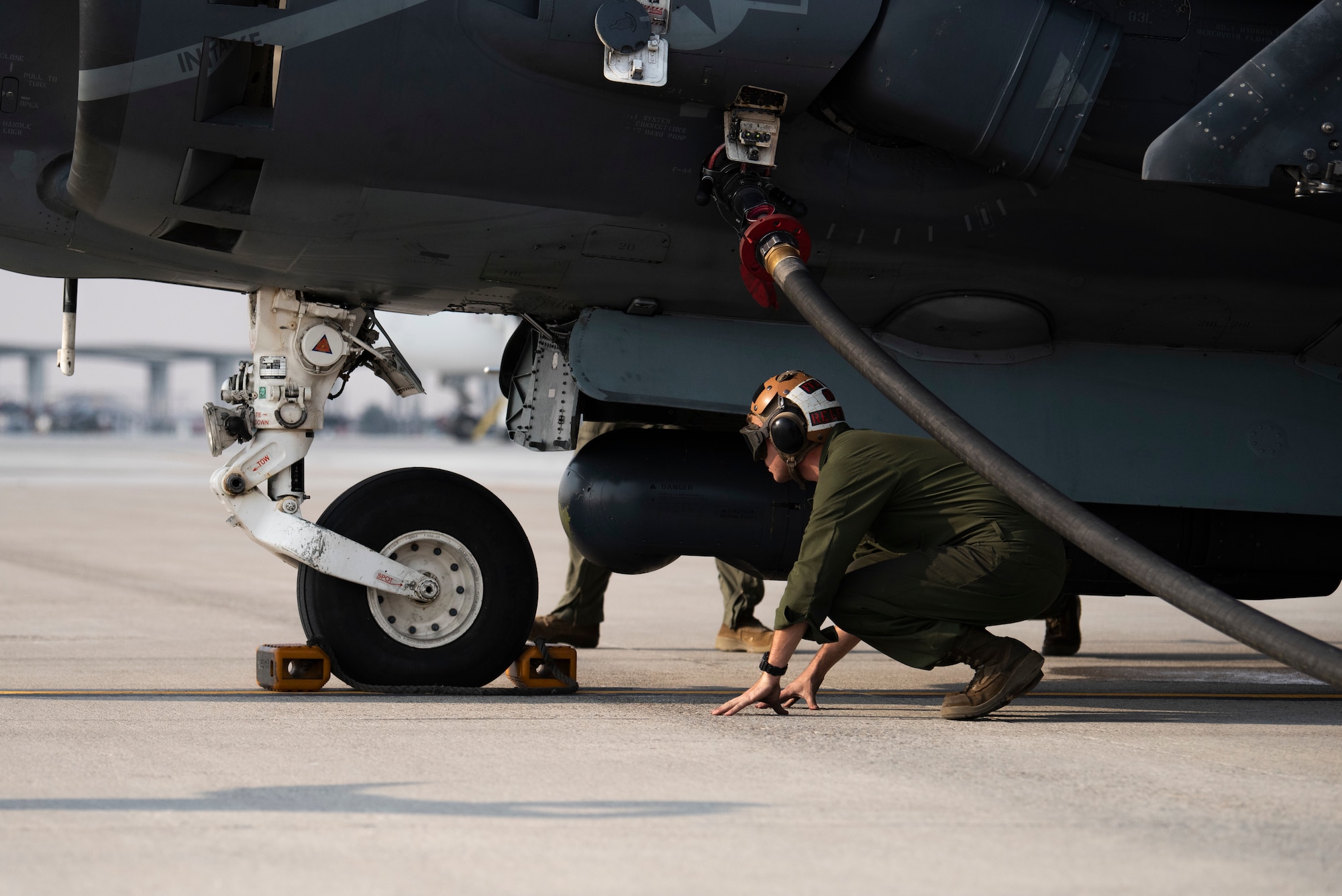 A U.S. Marine with Marine Attack Squadron 542, inspects a chock on an AV-8B II Harrier, at Mountain Home Air Force Base, Idaho, Oct. 8, 2020. VMA 542 and Marine Wing Support Squadron 271 worked closely with 366th Logistics Readiness Squadron fuels flight and provided aviation fuel, heavy equipment and utilities support for exercise Mountain Tiger. (U.S Air Force photo by Airman 1st Class Natalie Rubenak)