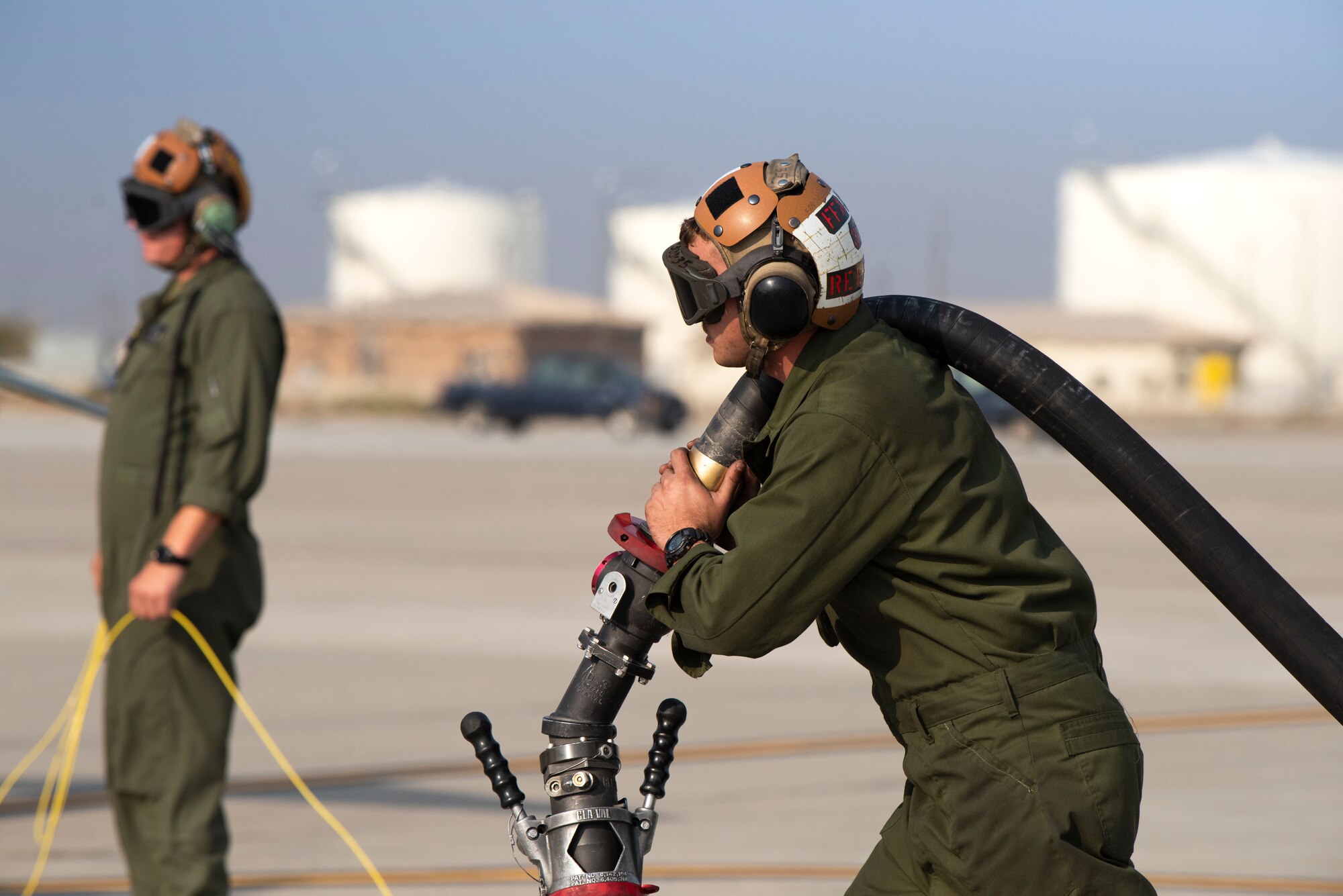 A U.S. Marine power liner with Marine Attack Squadron 542, prepares to refuel an AV-8B II Harrier, at Mountain Home Air Force Base, Idaho, Oct. 8, 2020. VMA 542 and Marine Wing Support Squadron 271 worked closely with 366th Logistics Readiness Squadron fuels flight and provided aviation fuel, heavy equipment and utilities support for exercise Mountain Tiger. (U.S Air Force photo by Airman 1st Class Natalie Rubenak)