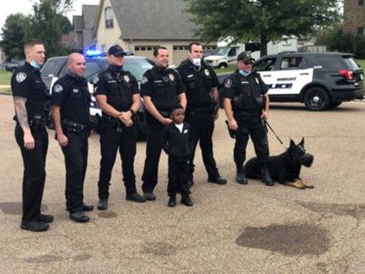 IN THE PHOTO, Bartlett police officers made a surprise visit to Contract Specialist Sequoria Wilson’s son’s birthday party, at her request, earlier this month. “They gave out goody bags to all the kids, took my son on a ride around the block, and took pictures," Wilson said. "The goody bags had masks, a BPD coin, coloring book, candy, toy shields, and more." (Courtesy photo)