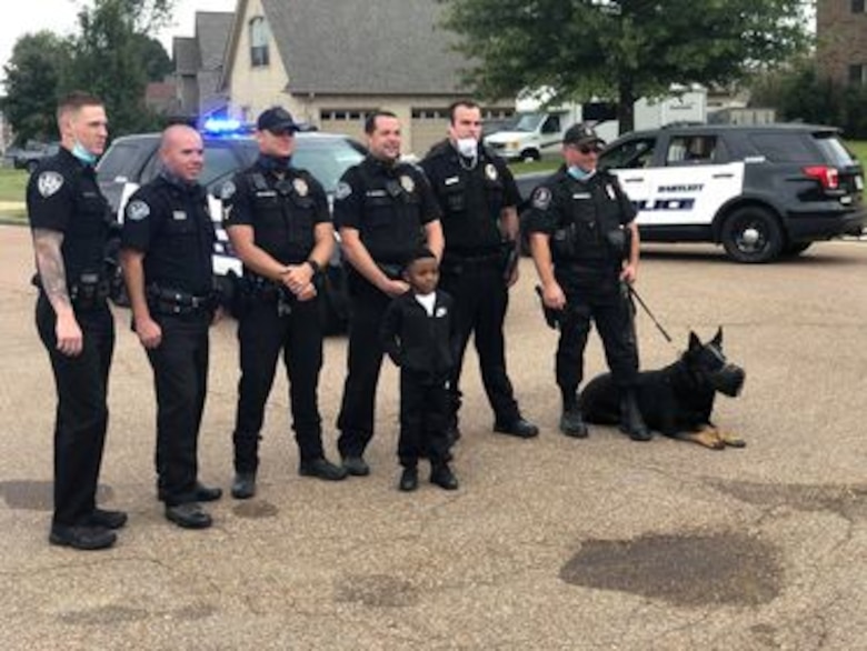 IN THE PHOTO, Bartlett police officers made a surprise visit to Contract Specialist Sequoria Wilson’s son’s birthday party, at her request, earlier this month. “They gave out goody bags to all the kids, took my son on a ride around the block, and took pictures," Wilson said. "The goody bags had masks, a BPD coin, coloring book, candy, toy shields, and more." (Courtesy photo)