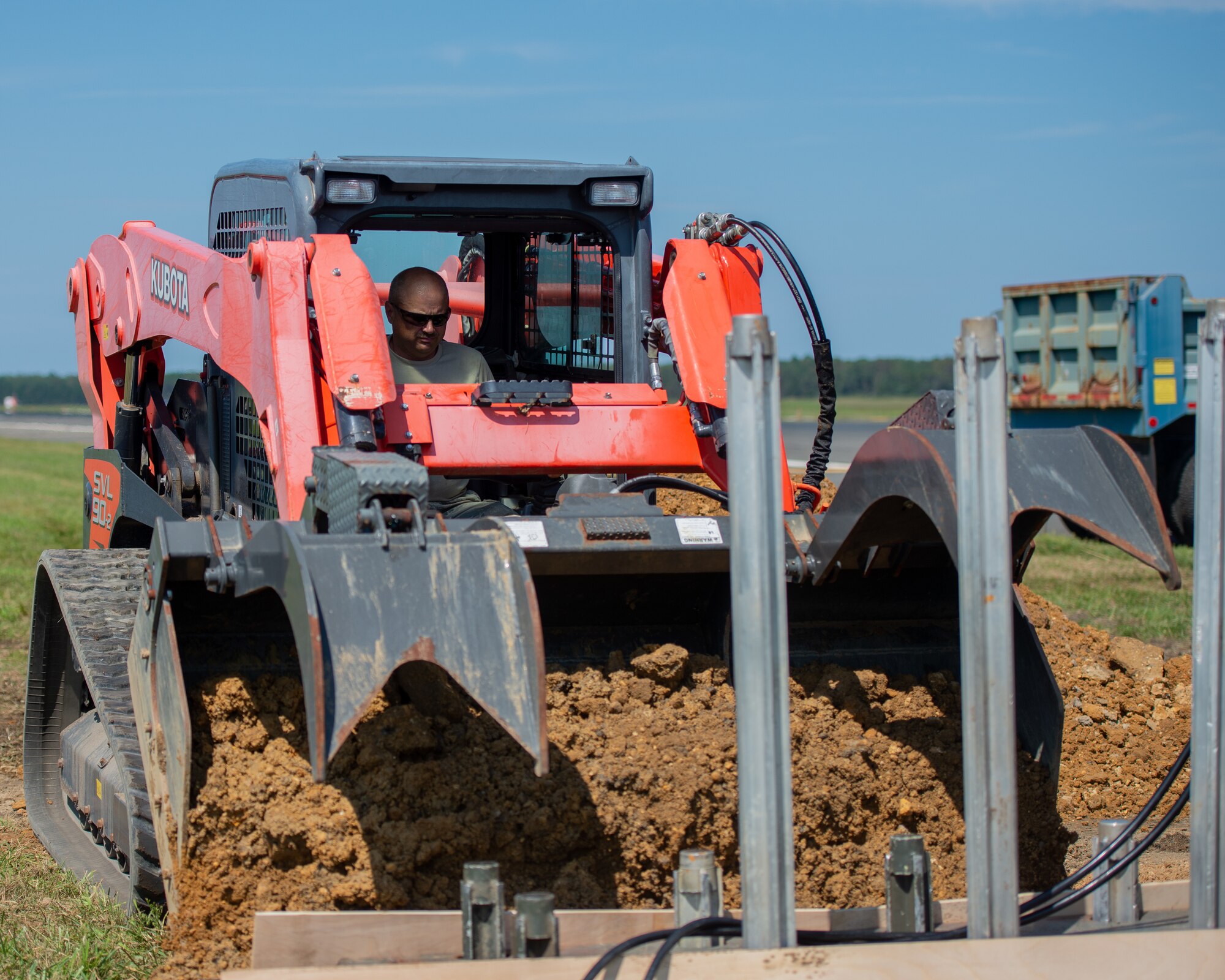 A photo of Senior Master Sgt. Ronald G. Huntzinger operating a track loader.