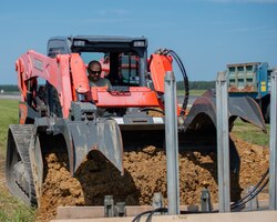 A photo of Senior Master Sgt. Ronald G. Huntzinger operating a track loader.
