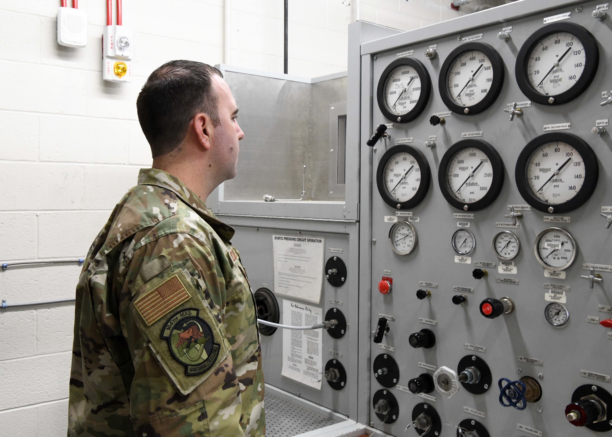 U.S. Air Force Tech. Sgt. Edward McGaughey, 104th Maintenance Squadron hydraulic systems supervisor, reads a back shop hydraulic test station. The hydraulic test station is useful for measuring the proper operation of hydraulic cylinders. (U.S. Air National Guard Photo by Airman 1st Class Camille Lienau)