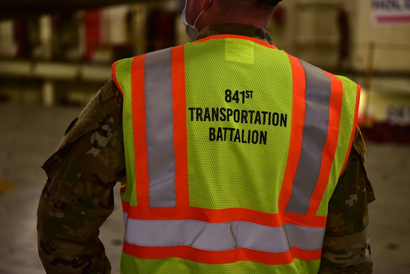 U.S. Army Sgt. 1st Class Blake Interdonato, an Operations NCOIC mobilized with the 841st Transportation Battalion, monitors equipment being offloaded from a cargo vessel at Joint Base Charleston’s Naval Weapons Station, S.C., Oct. 14, 2020. The 841st TB is an active duty, U.S. Army Surface Deployment and Distribution Command (SDDC) unit tasked with the execution of Task Force Deployment Operations.