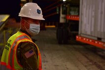 U.S. Army Sgt. 1st Class Blake Interdonato, an Operations NCOIC mobilized with the 841st Transportation Battalion, monitors equipment being offloaded the cargo vessel at Joint Base Charleston’s Naval Weapons Station, S.C., Oct. 14, 2020. The 841st TB is an active duty, U.S. Army Surface Deployment and Distribution Command (SDDC) unit tasked with the execution of Task Force Deployment Operations.