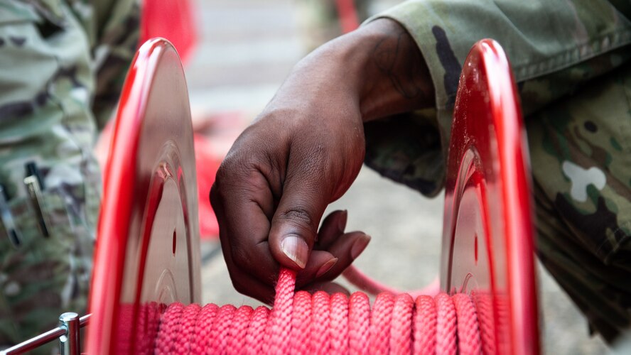 Staff Sgt. Jalen Allen, 2nd Security Forces Squadron supply NCO in-charge, prepares rope while setting up for Global Thunder 21 at Barksdale Air Force Base, La., Oct. 20, 2020.