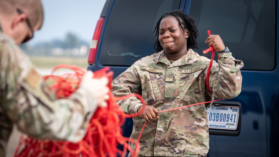 Staff Sgt. Porsche Jones, 2nd Security Forces Squadron physical security NCO in-charge, untangles rope while setting up for Global Thunder 21 at Barksdale Air Force Base, La., Oct. 20, 2020.