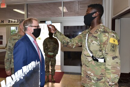 Thomas McCaffery, Assistant Secretary of Defense for Health Affairs, has his temperature checked while entering Willis Hall on his visit to the U.S. Army Medical Center of Excellence at Joint Base San Antonio-Fort Sam Houston Oct. 19.
