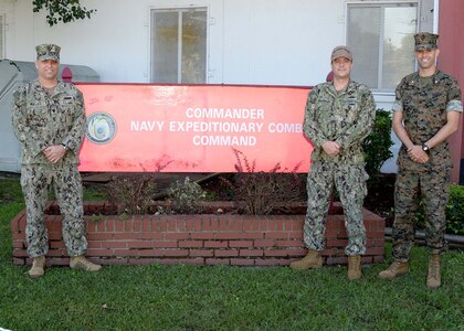Navy Expeditionary Combat Command (NECC) Operations Officers pose for a photograph at the NECC sign in front of the command headquarters.
