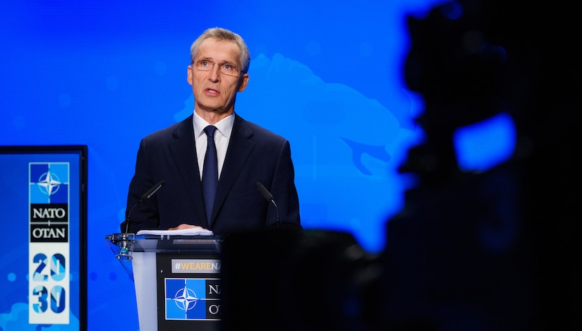 A man speaks from a lectern.