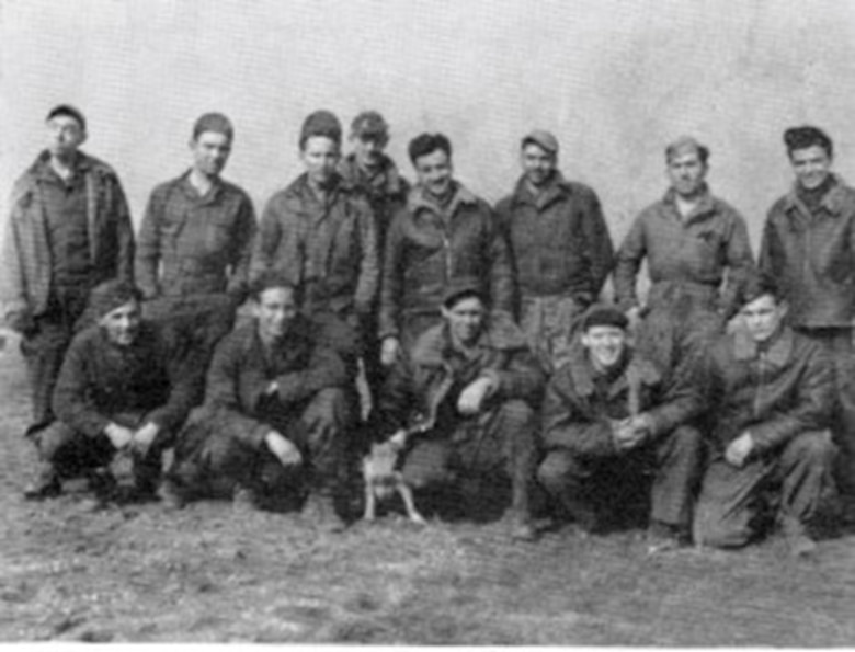 Cpl. Victor B. Kramer is the man either to the left or the right of the pooch (probably to left) in this picture of 404th Fighter Squadron enlisted men – an incomplete roster of names in the original caption makes it difficult to correlate precisely.  (From “The Story of the 371st Fighter Group in the E.T.O.)