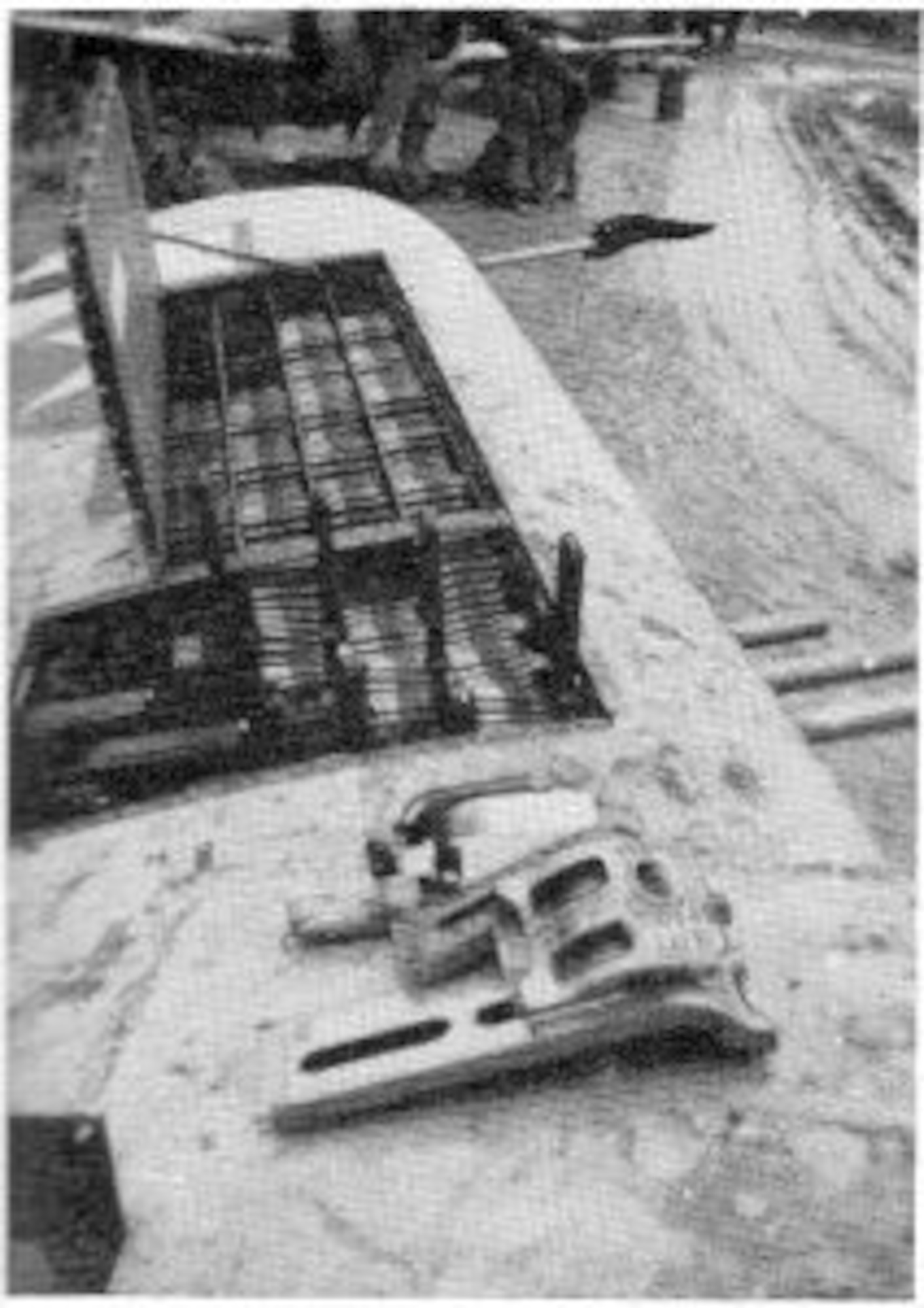 The gun bay and ammunition storage trays atop one wing are opened for servicing in this view of a 371st Fighter Group P-47 Thunderbolt at a muddy airfield on the Continent.  (The Story of the 371st Fighter Group in the E.T.O.)