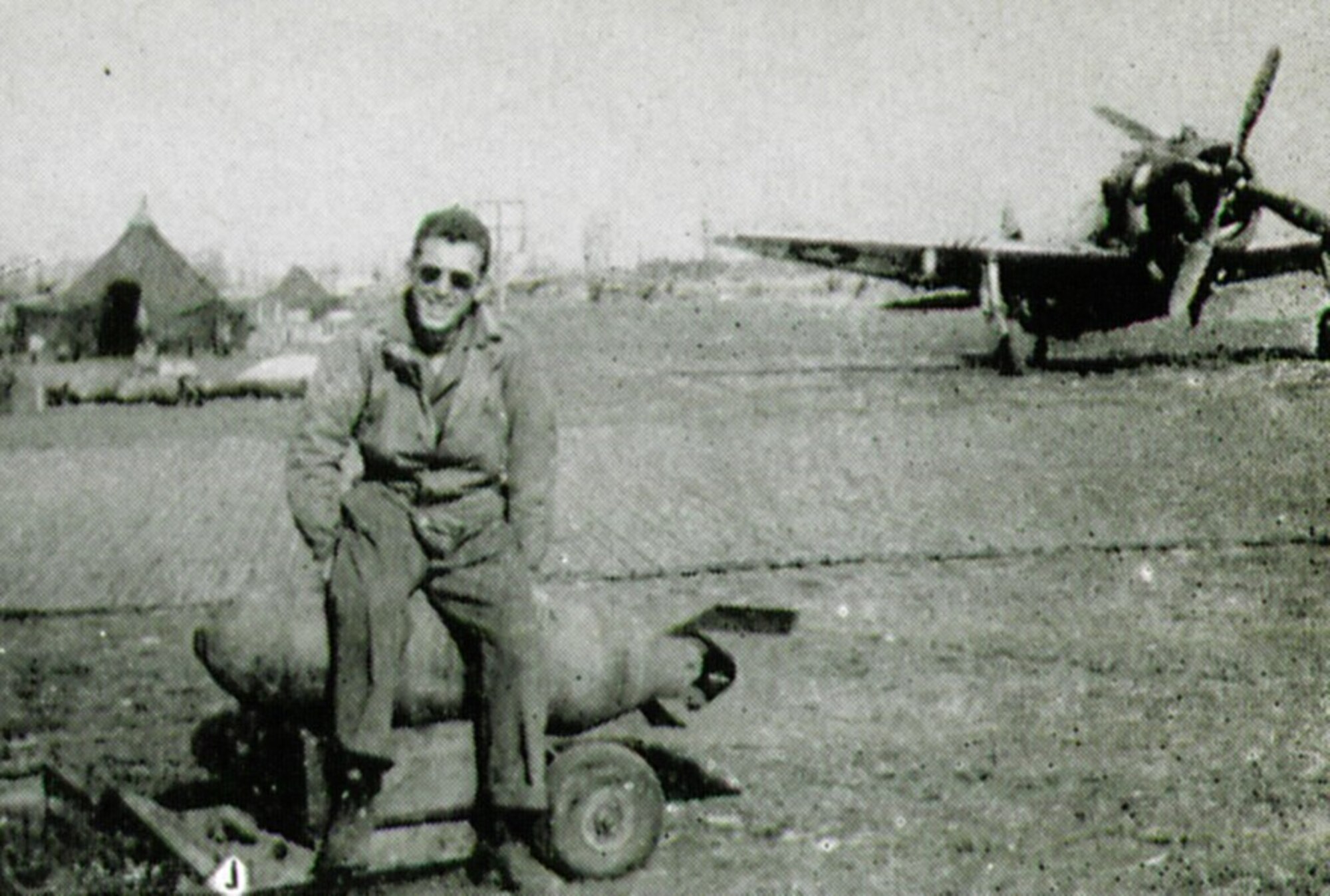 405th Fighter Squadron Sgt. Nicholas Pacelia unconcernedly tries to hatch this 500 LB egg. (The Story of the 371st Fighter Group in the E.T.O.)