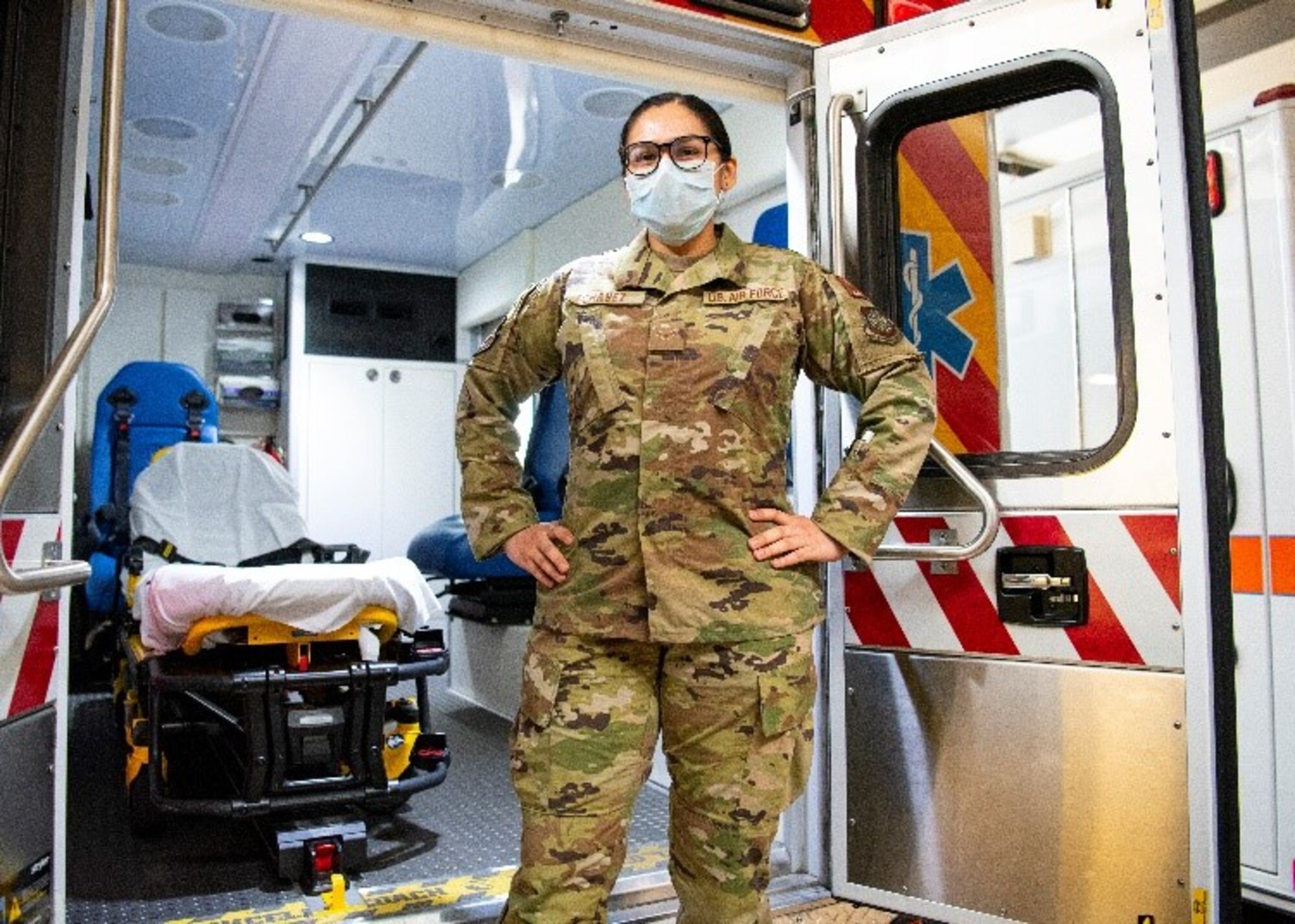 An Airman poses by an ambulance truck.