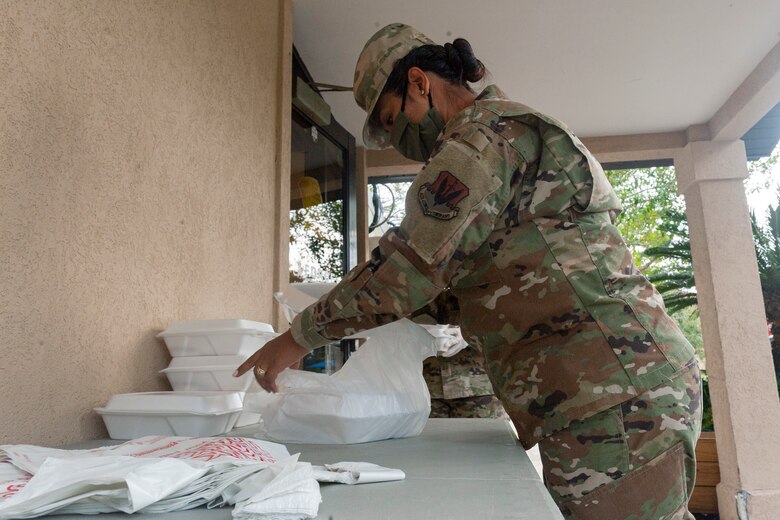 Photo of an Airman bagging meals