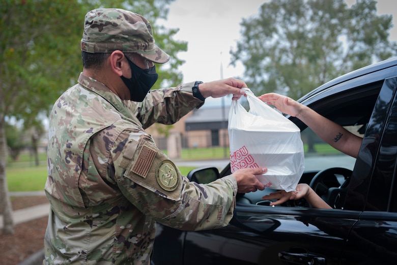 Photo of an Airman delivering meals