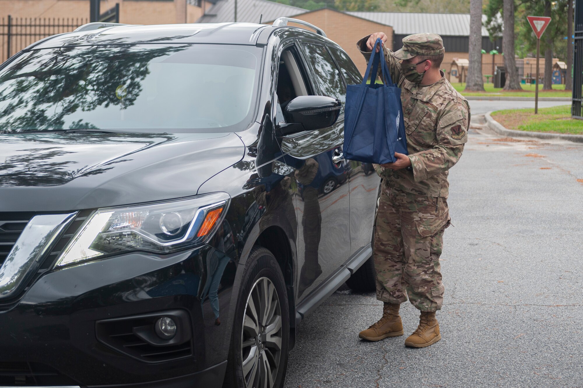 Photo of an Airman delivering a gift bag