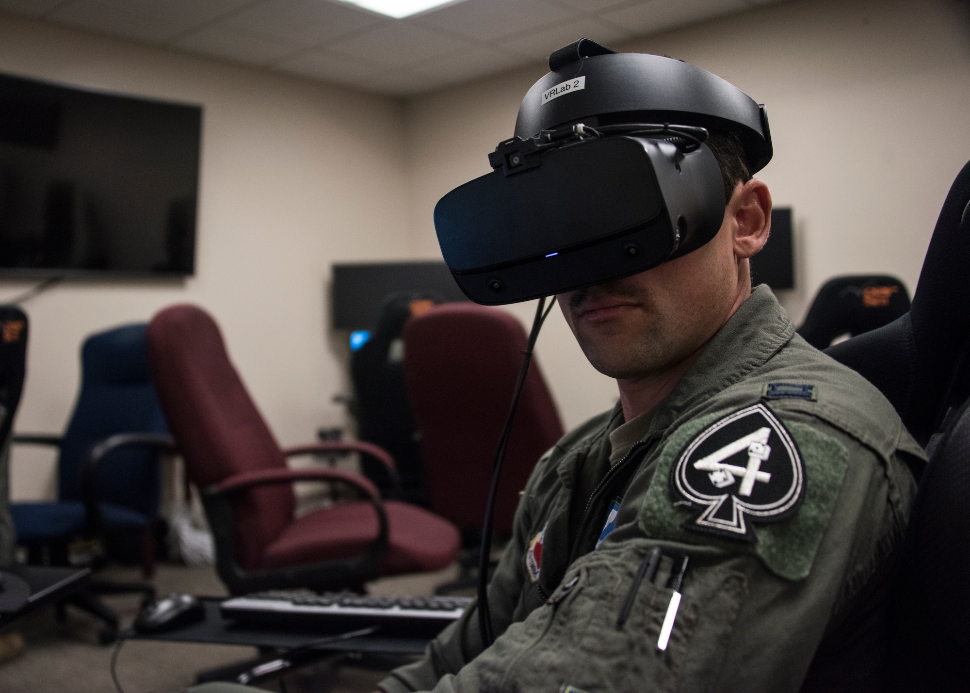 A photo of a pilot training on a VR simulator