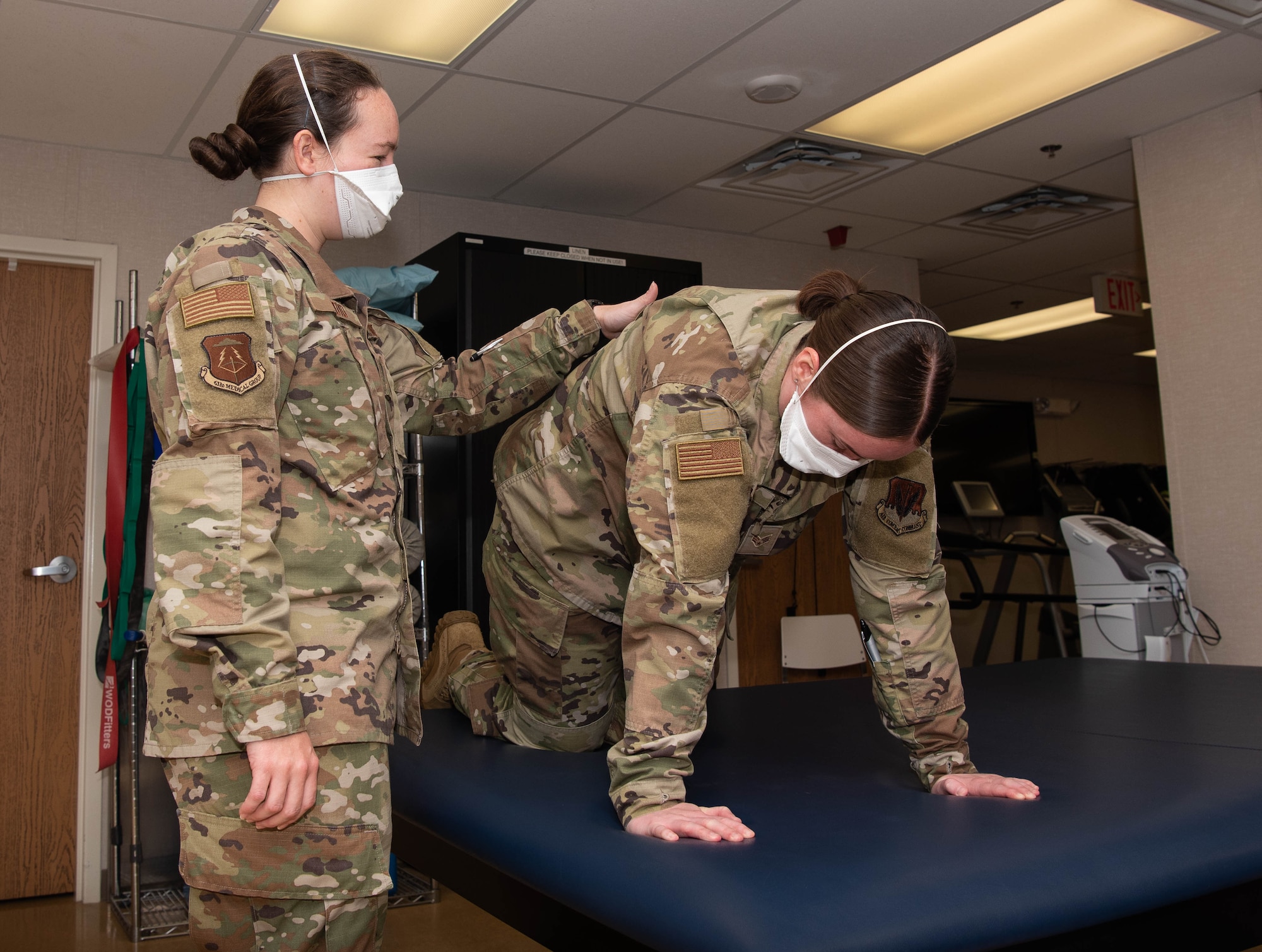 U.S. Air Force Senior Airman Devyn Gaffney performs a Cat-Cow stretch.