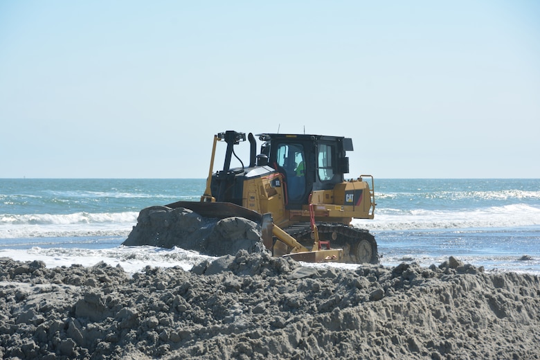 Great Lakes Dredge and Dock Company, LLC, NII member, utilizes one of their Cat D7Es to perform beach nourishment by beneficially using dredged materials.