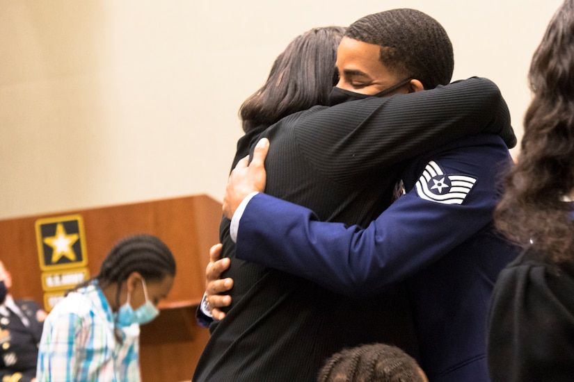 Eldridge Rouse and his mother Evelyn Rouse hug each other after being reunited  at U.S. Army Central headquarters on Shaw Air Force Base, S.C., Oct. 7, 2020. The Rouse family were together to attend Tyris' retirement ceremony which turned out to be a surprise reunion for Eldridge and the family. (U.S. Army photo by Pfc. Keon Horton)