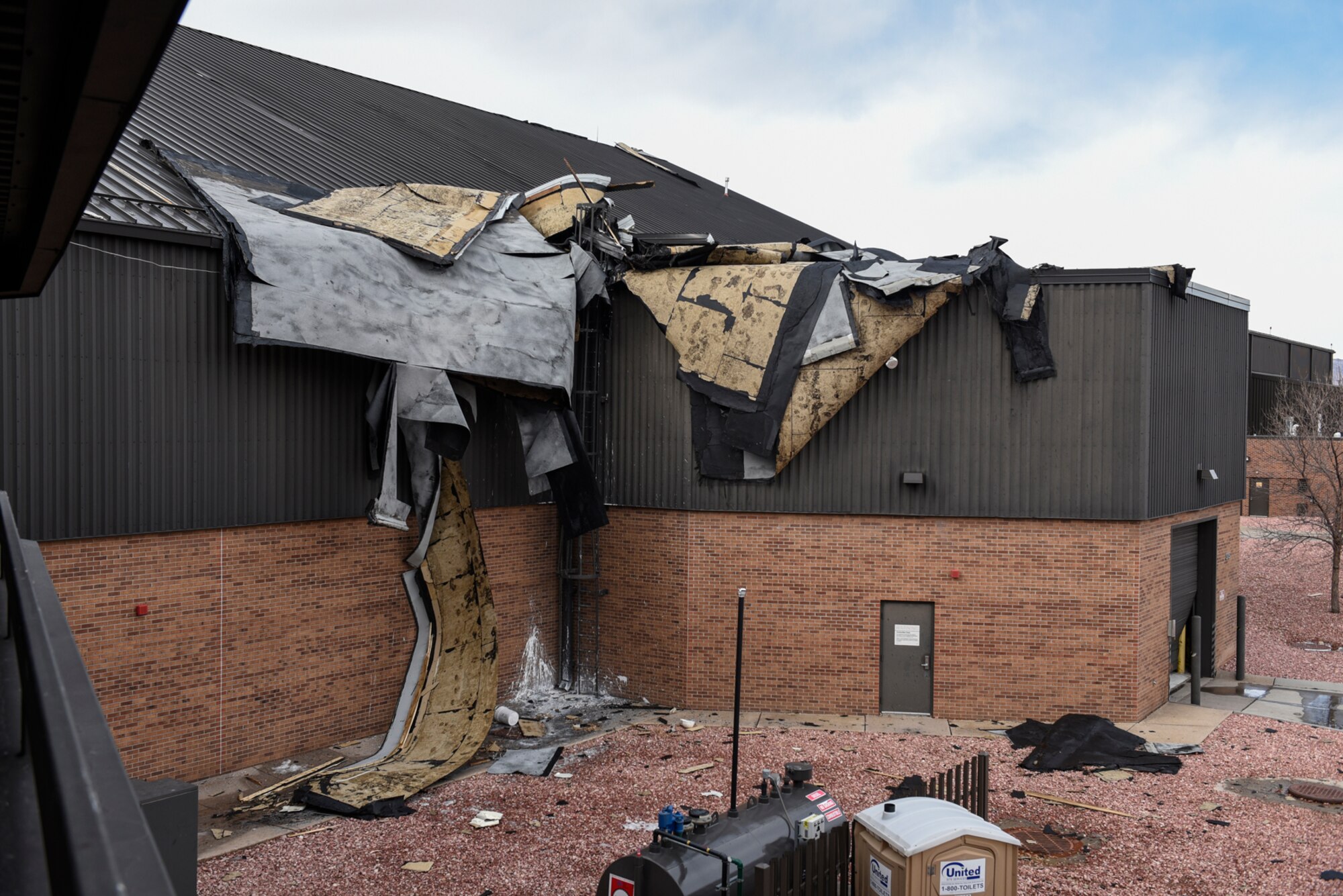 The entire roof of a hangar next to the flightline at Peterson Air Force Base, Colorado, is lifted off the structure during a wind storm Jan. 9, 2017.