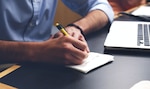 Man writing on notepad