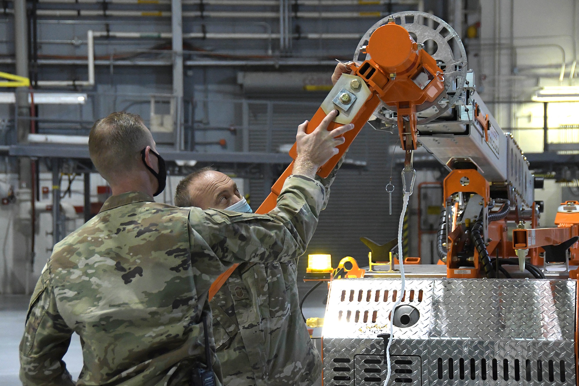 Senior Master Sgt. Jeff Pierce and Master Sgt. Brian Cochran, from 94th Aircraft Maintenance Squadron, install an arm on the new fall protection system during a training session at Dobbins Air Reserve Base, Georgia, Oct. 16, 2020. The 94th Aircraft Maintenance Squadron recently acquired five mobile fall protection systems to improve the safety of maintainers and operators as they perform their duties on the aircraft. (U.S. Air Force photo/Andrew Park)