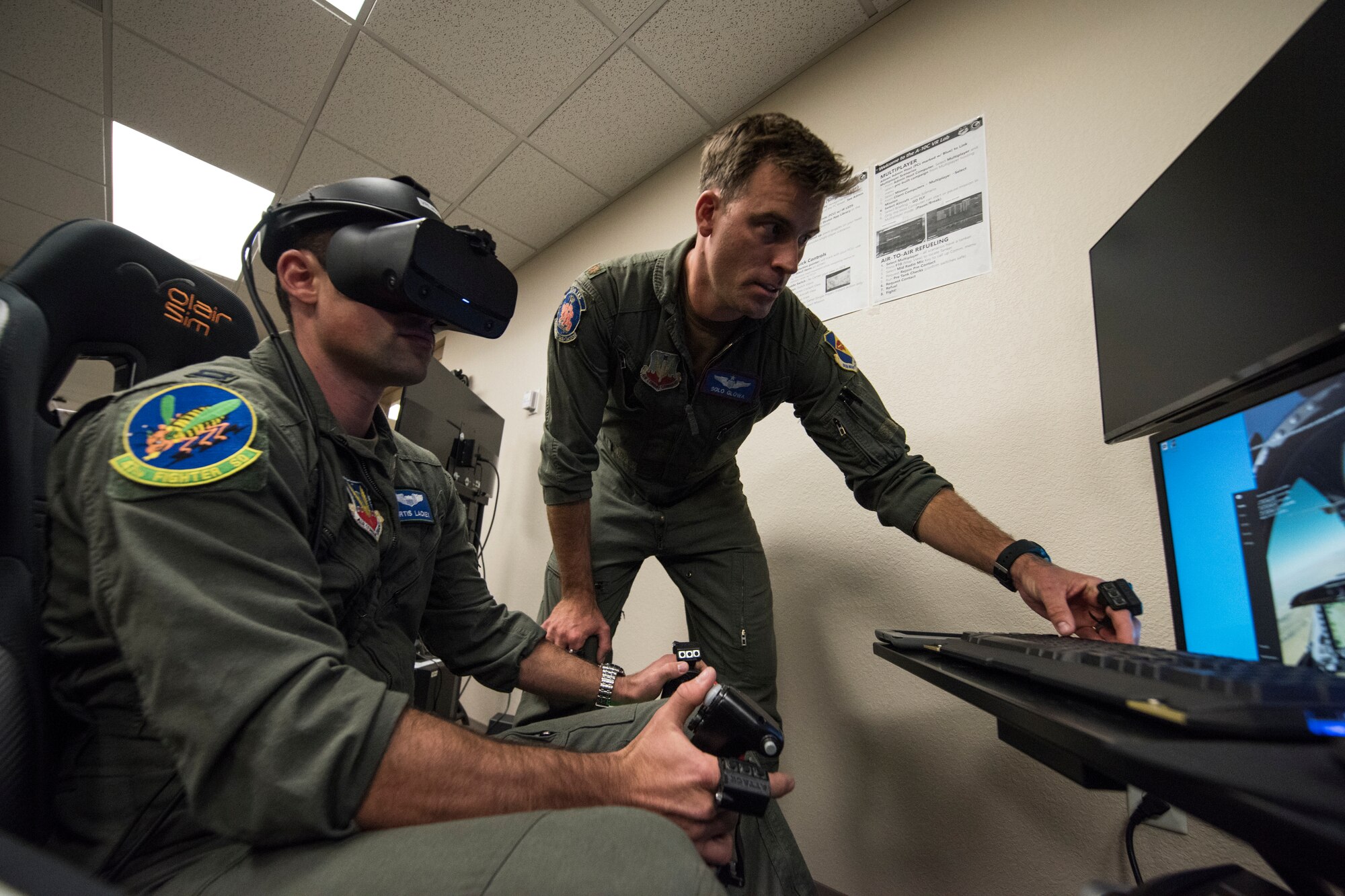 A photo of a pilot training on a VR simulator