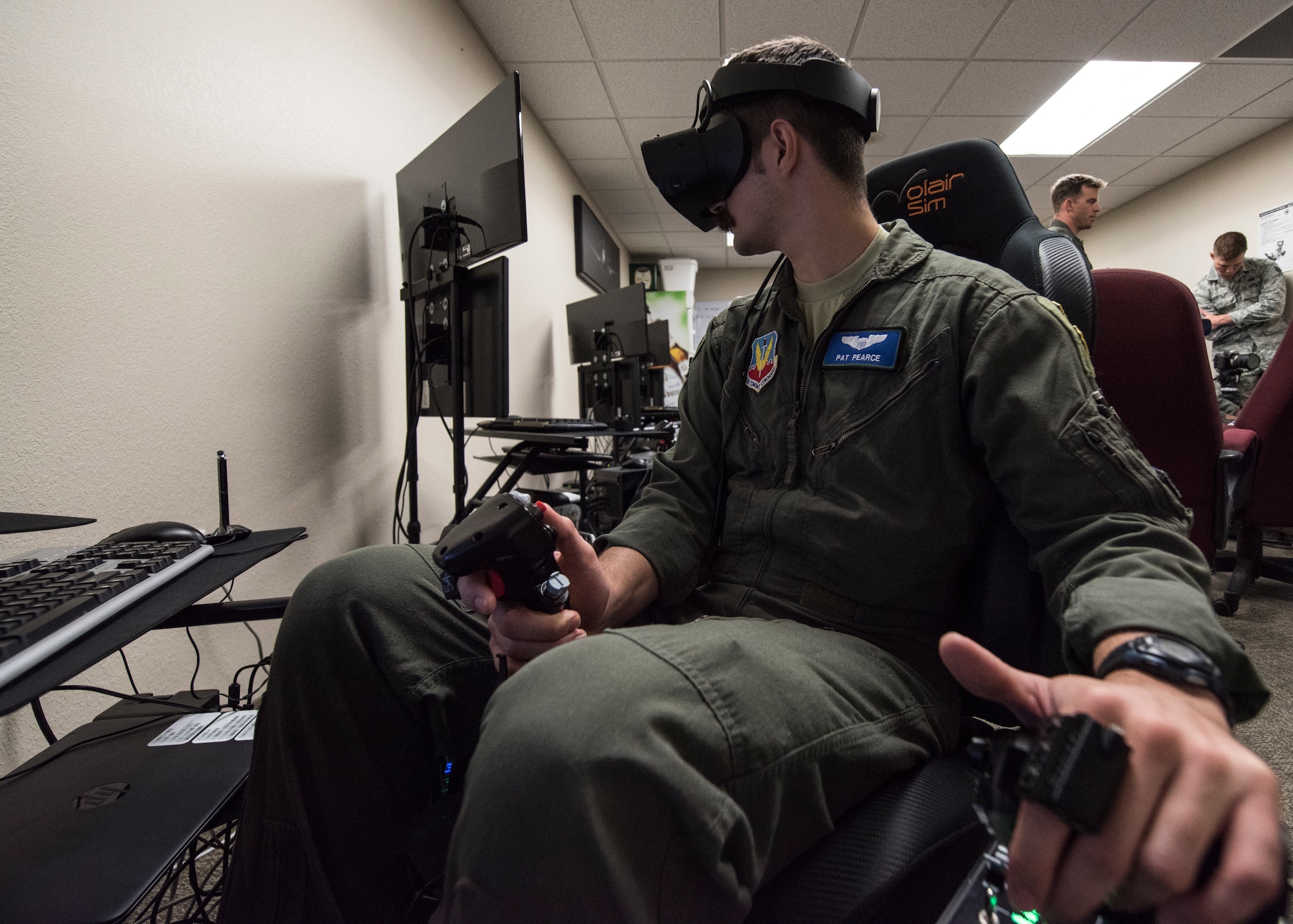 A photo of a pilot training on a VR simulator