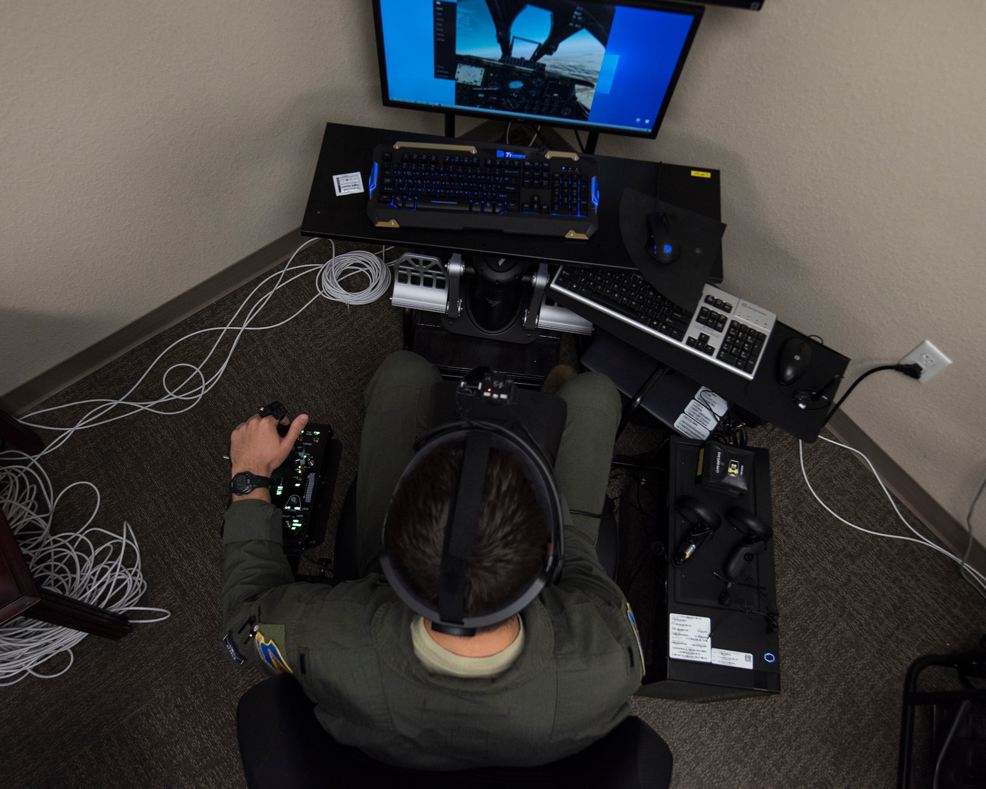 A photo of a pilot training on a VR simulator