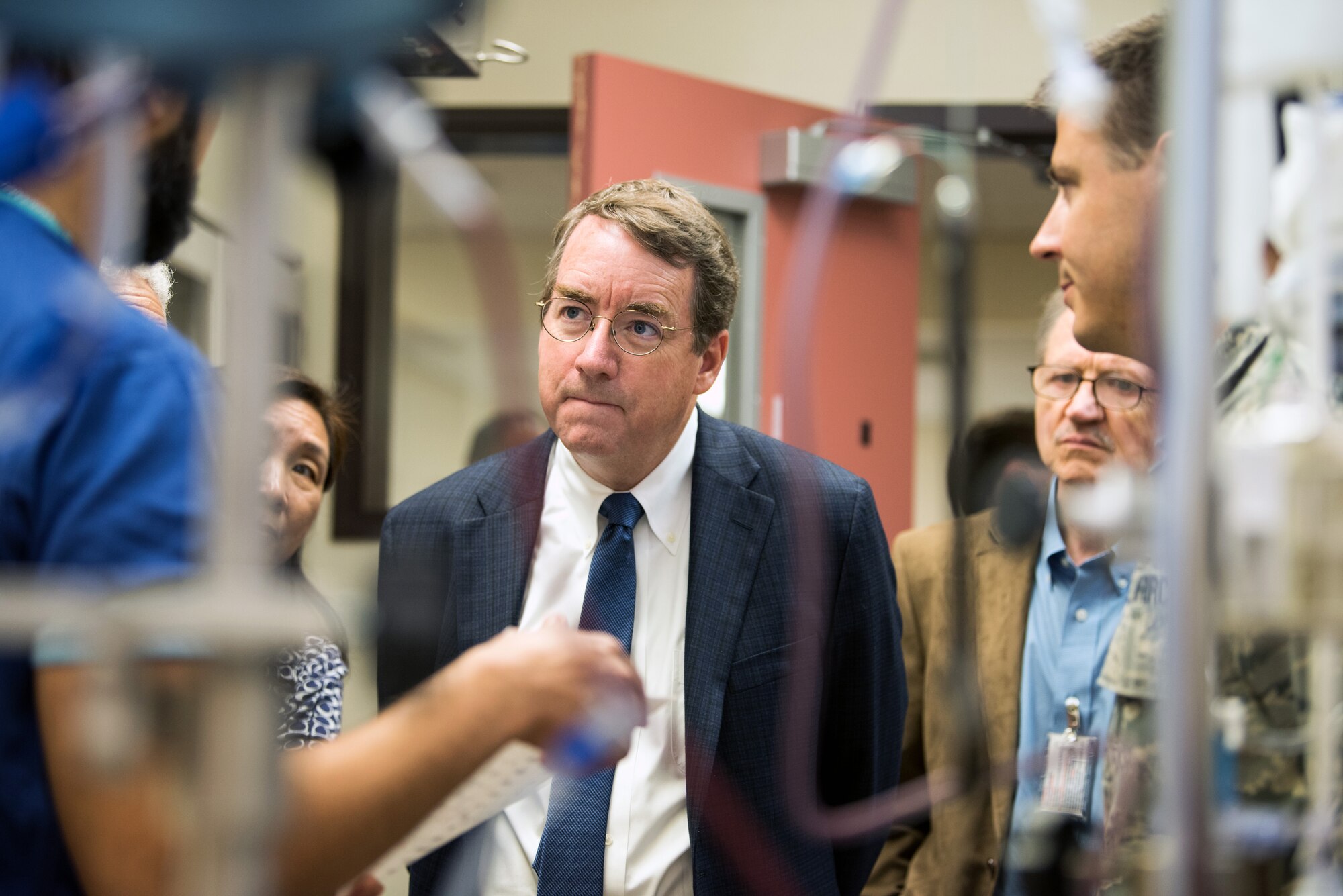 A research doctor listens to Airmen discuss procedures in a clinical investigation facility.